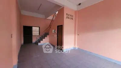 Spacious interior with high ceilings and staircase, ideal for customization.