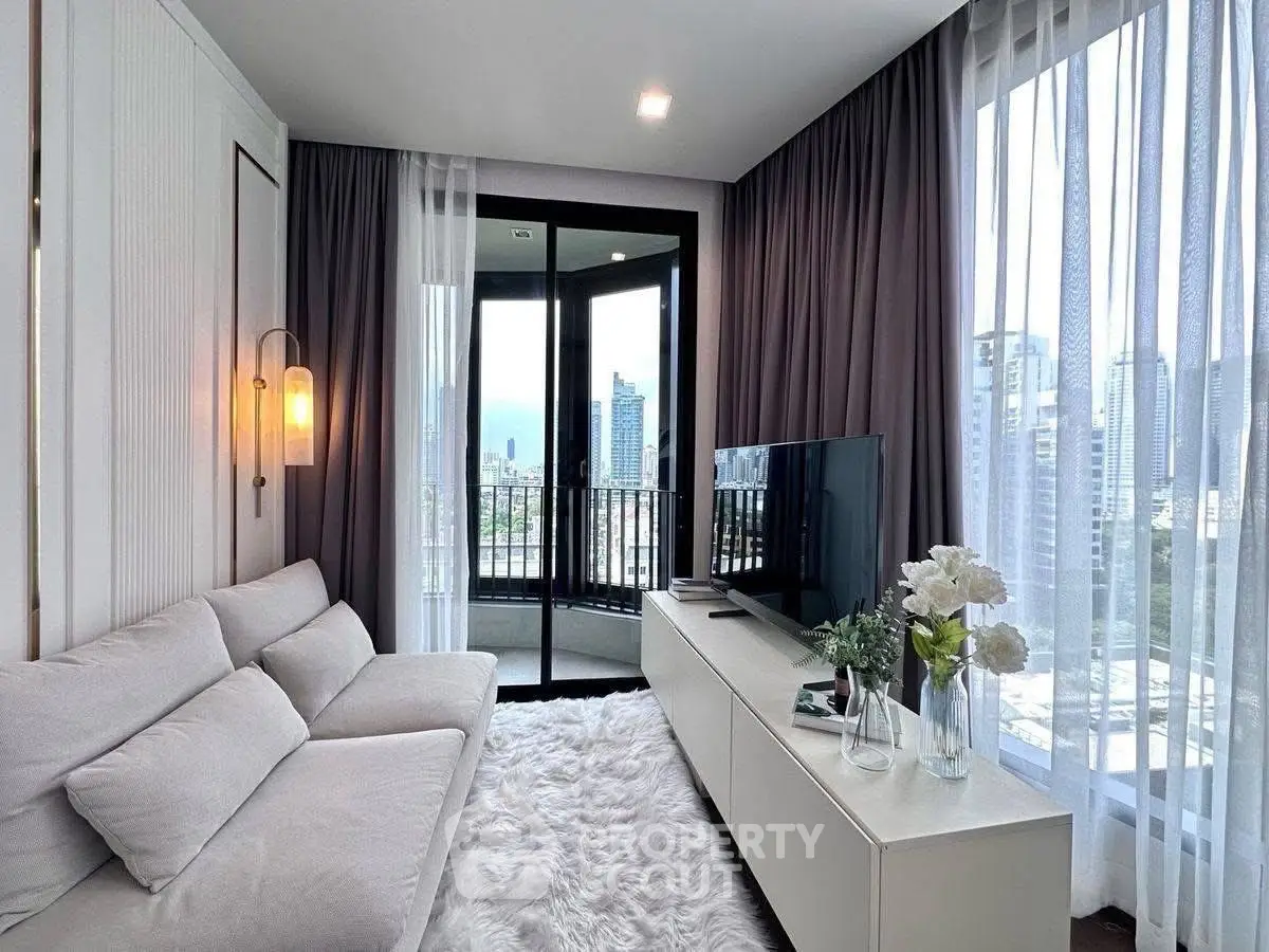 Modern living room with city view, cozy white sofa, and elegant decor
