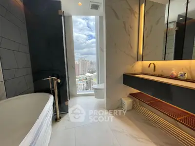 Luxurious bathroom with city view, featuring modern fixtures and elegant design.