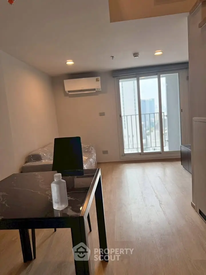 Modern living room with balcony view in high-rise apartment