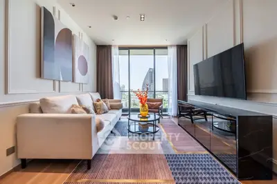 Luxurious living room with modern decor and stunning city view, featuring a large TV and elegant furniture.