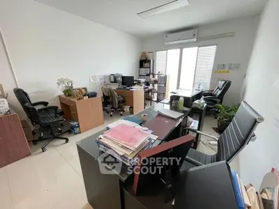 Spacious office space with modern furniture and natural lighting