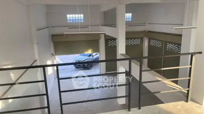 Spacious industrial warehouse with high ceilings and ample natural light, featuring secure roller doors and mezzanine level.