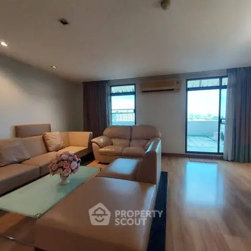 Spacious living room with modern furniture and balcony view