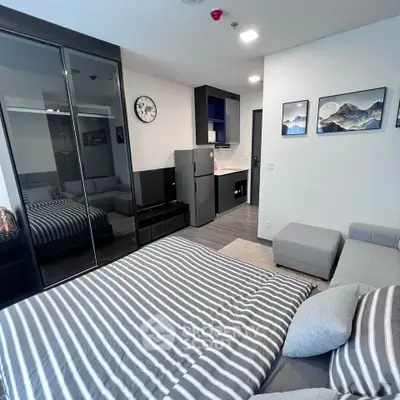 Modern studio apartment with stylish decor and compact kitchen
