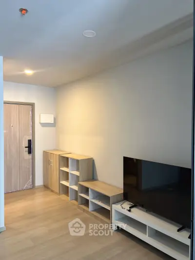 Modern living room with sleek wooden flooring and minimalist TV stand