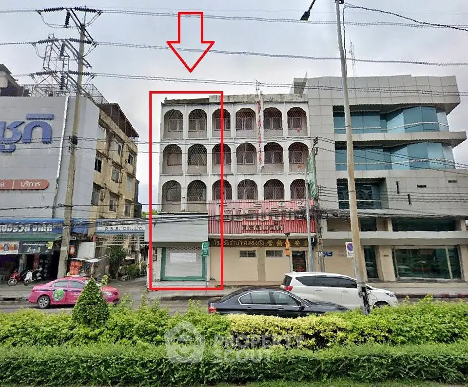 Prime commercial building with modern facade on bustling street, ideal for business opportunities.