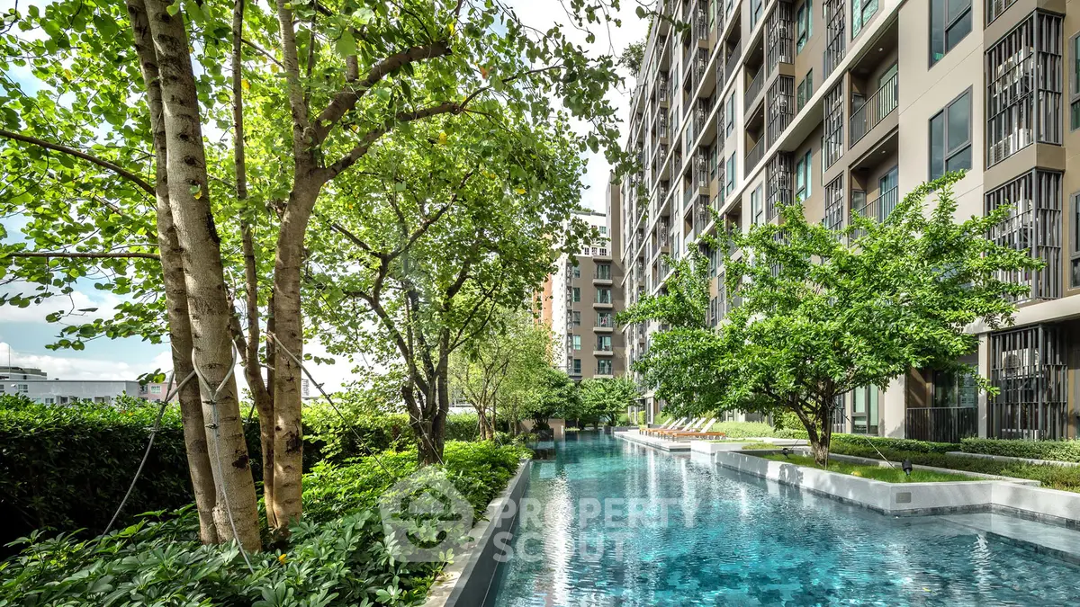 Luxurious condominium with stunning pool and lush greenery for serene living.