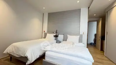 Modern bedroom with twin beds and stylish decor in a contemporary apartment