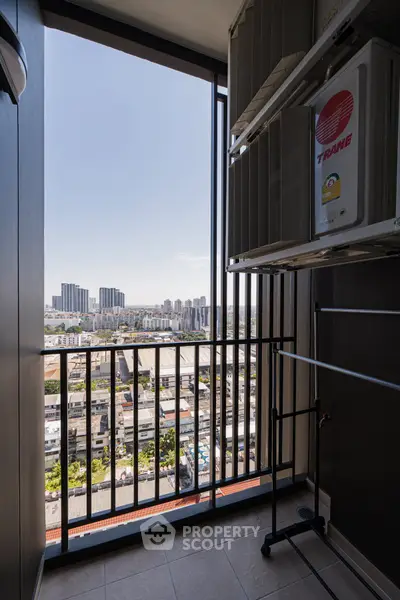 High-rise balcony with city view and air conditioning unit