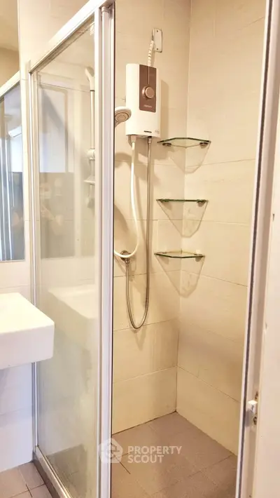 Modern bathroom with glass shower enclosure and wall-mounted water heater