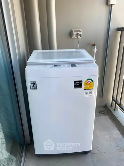 Modern washing machine on a balcony with a sleek design and energy-efficient features.