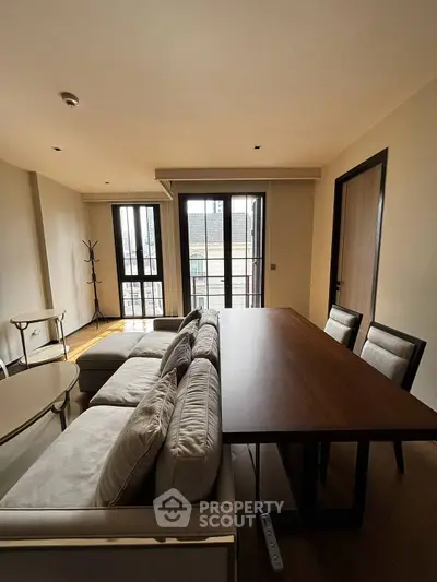 Spacious living room with modern furniture and large windows offering natural light.
