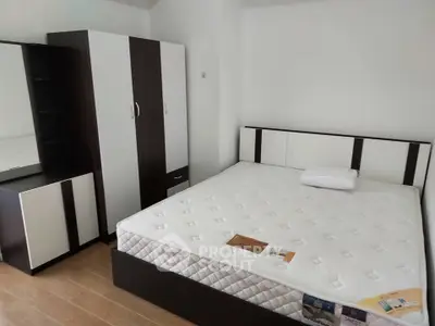 Spacious bedroom with modern furniture and comfortable mattress for ultimate relaxation.