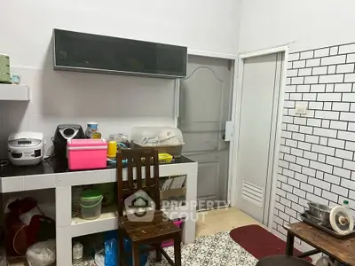 Cozy kitchen with modern appliances and stylish white brick wall tiles.