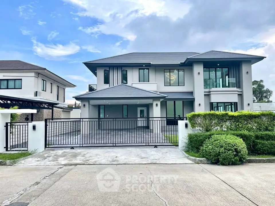 Stunning modern two-story house with sleek design and spacious driveway in a serene neighborhood.