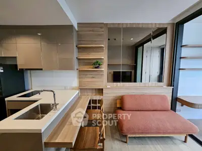 Modern open-plan kitchen and living area with sleek design and cozy seating.