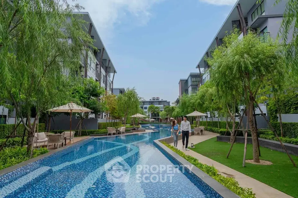 Luxurious residential complex with stunning outdoor pool and lush greenery.