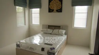 Cozy bedroom with natural light and modern decor in a stylish apartment.