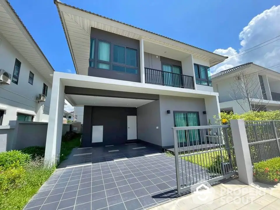 Modern two-story house with spacious driveway and lush garden