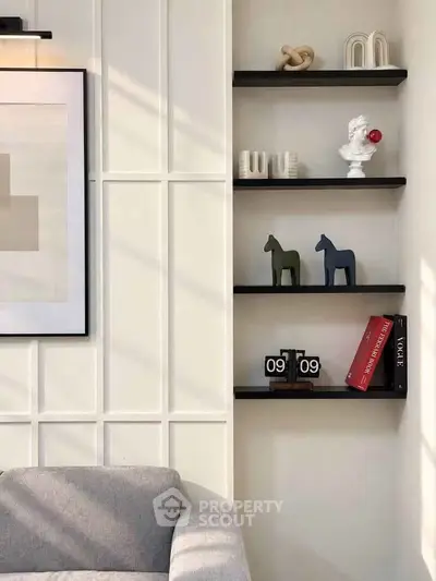 Stylish modern living room with elegant shelving and artistic decor