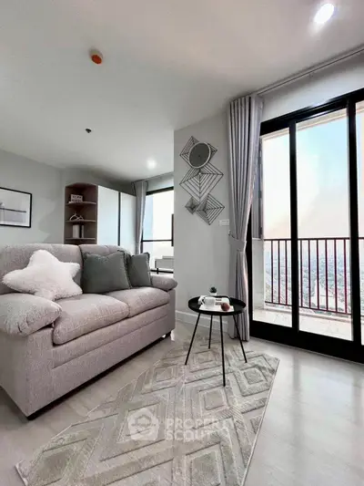 Modern living room with cozy sofa and stunning city view from large windows.