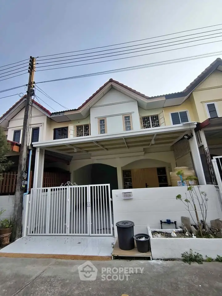 Charming townhouse with gated entrance and covered parking in a serene neighborhood.