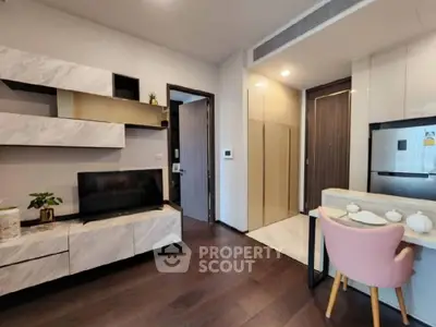 Modern apartment interior with integrated living space, featuring sleek kitchen appliances, a cozy dining area, and a stylish entertainment unit.