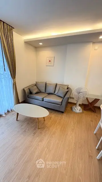 Cozy living room with modern sofa and stylish decor, perfect for relaxation.