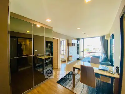 Modern living room with sleek furniture and large windows offering natural light and a spacious feel.