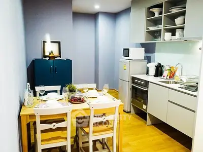 Charming kitchen with modern appliances and cozy dining area, perfect for intimate gatherings.