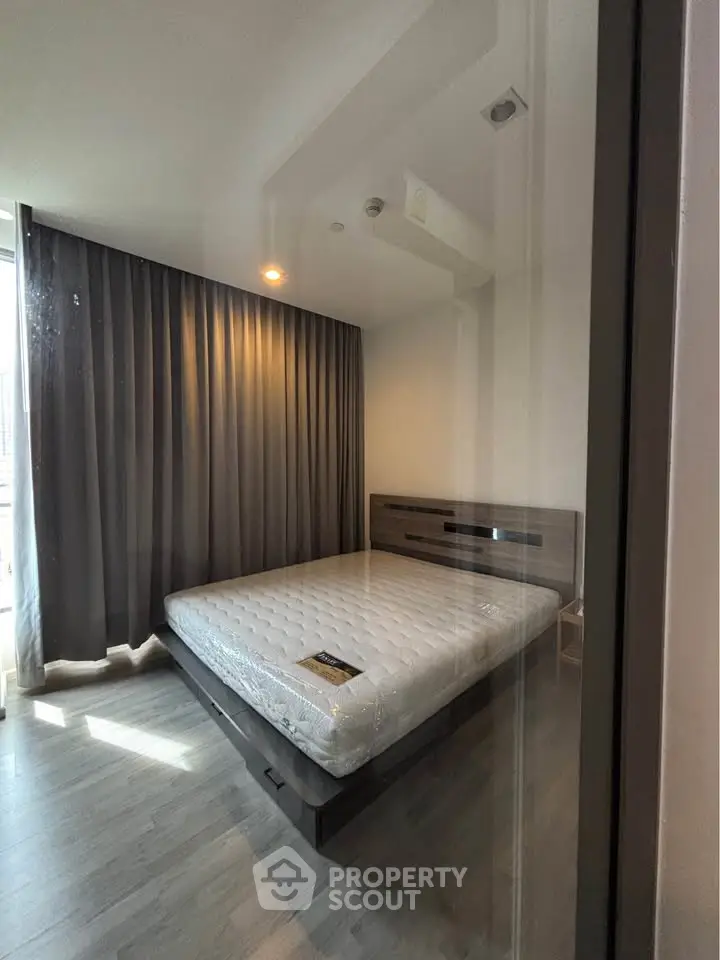 Modern bedroom with sleek design and large window for natural light