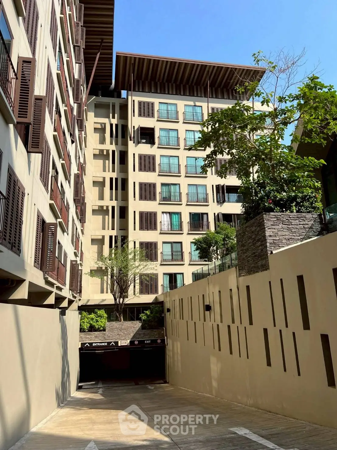 Modern residential building with stylish facade and lush greenery, showcasing urban living at its finest.