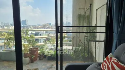 Spacious balcony with urban skyline views, offering a serene outdoor retreat in a bustling city, perfect for relaxation and entertaining.