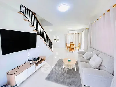 Spacious modern living room with sleek staircase and elegant decor