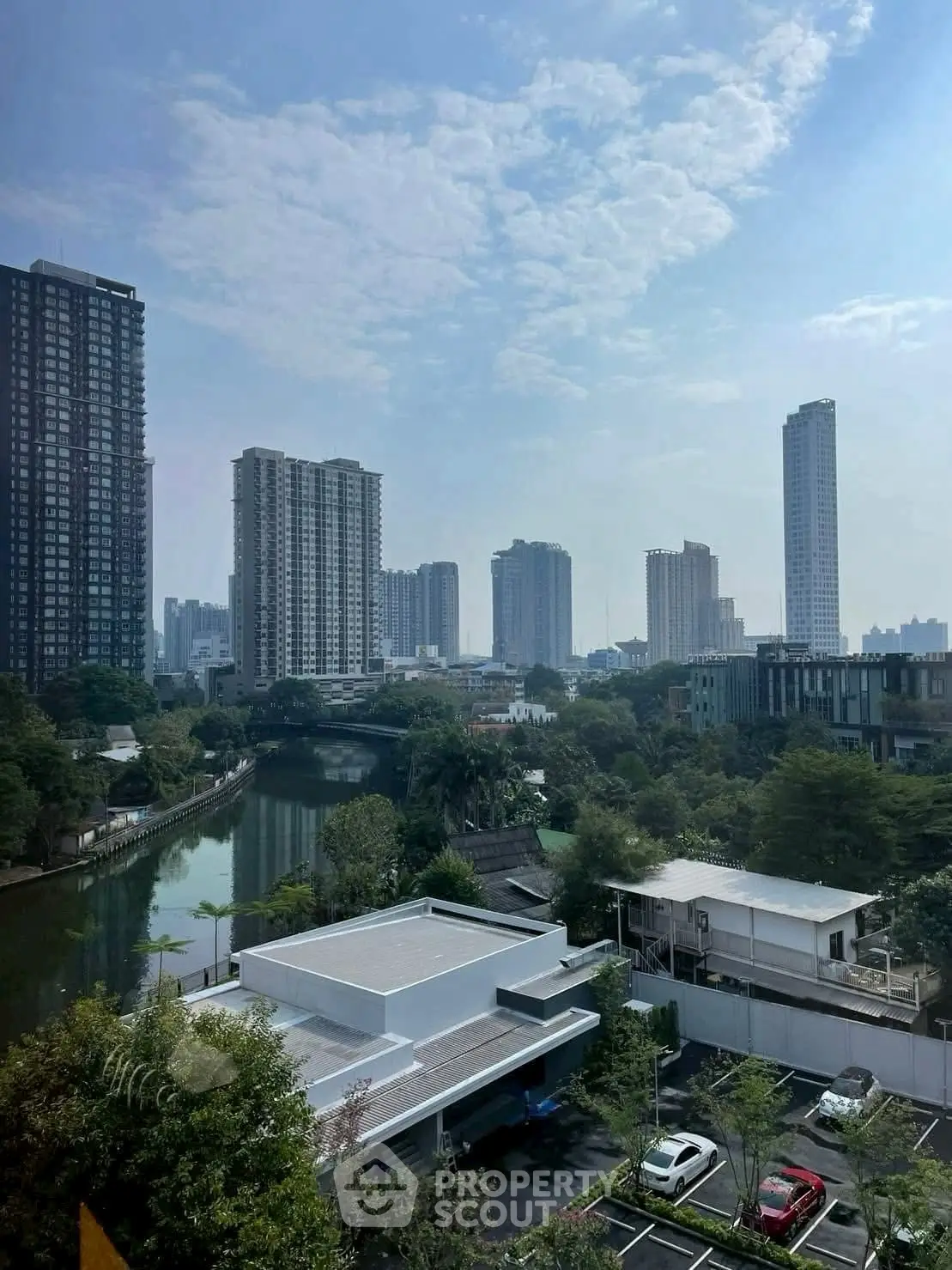 Stunning cityscape view with modern high-rise buildings and serene river, perfect for urban living.