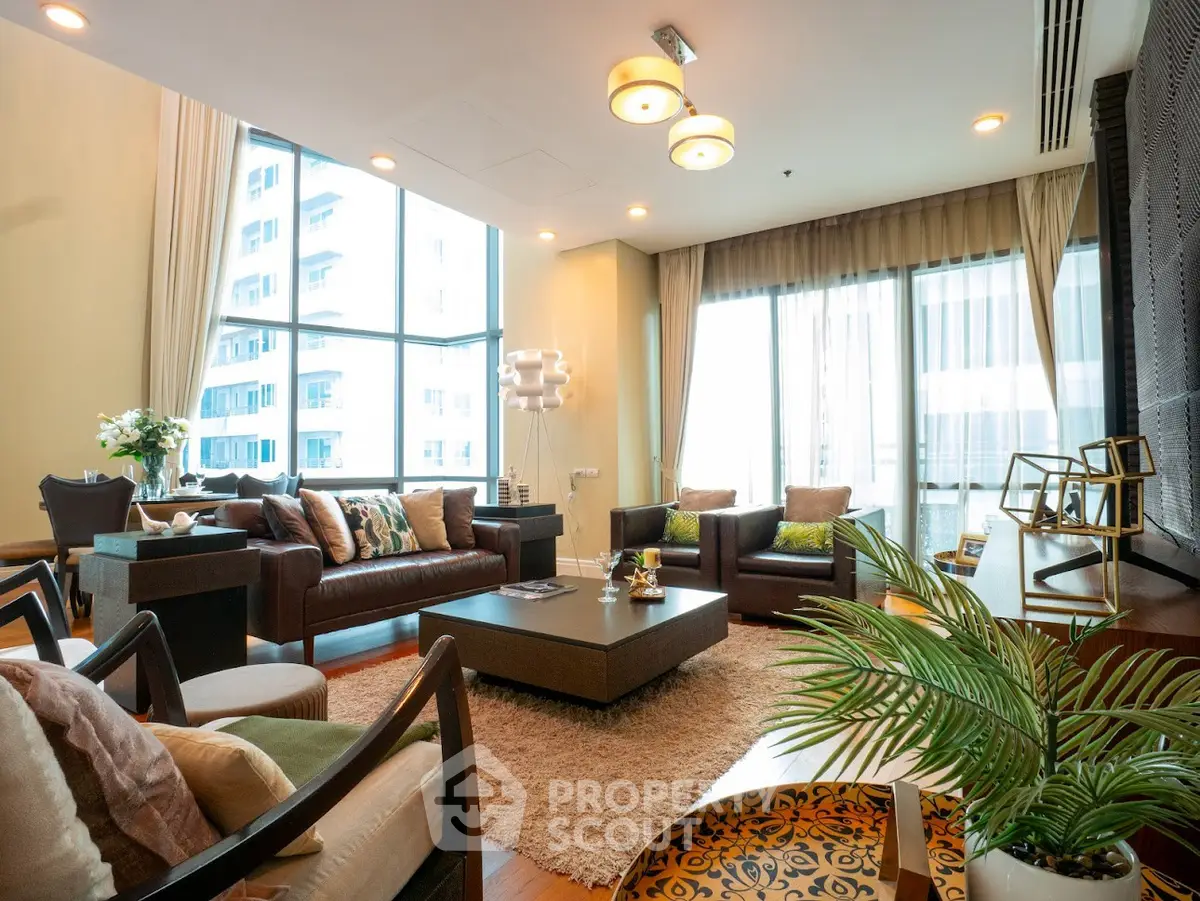 Luxurious living room with modern decor and large windows offering city views.