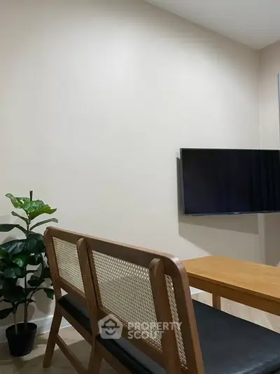 Modern living room with sleek furniture and wall-mounted TV, perfect for cozy gatherings.