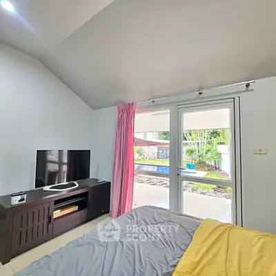 Cozy bedroom with garden view and modern entertainment setup