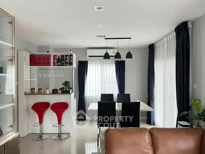 Modern dining area with sleek furniture and stylish lighting in a contemporary home.