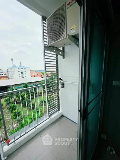 Charming balcony with scenic view and air conditioning unit in modern apartment.