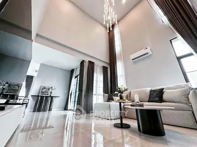 Luxurious high-ceiling living room with modern decor and elegant lighting