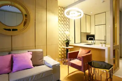 Modern living room with stylish decor and open kitchen layout, featuring elegant lighting and cozy seating.