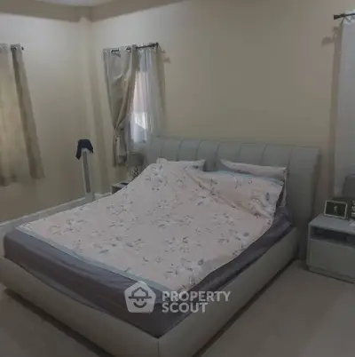 Cozy bedroom with elegant bed and soft lighting, perfect for relaxation.