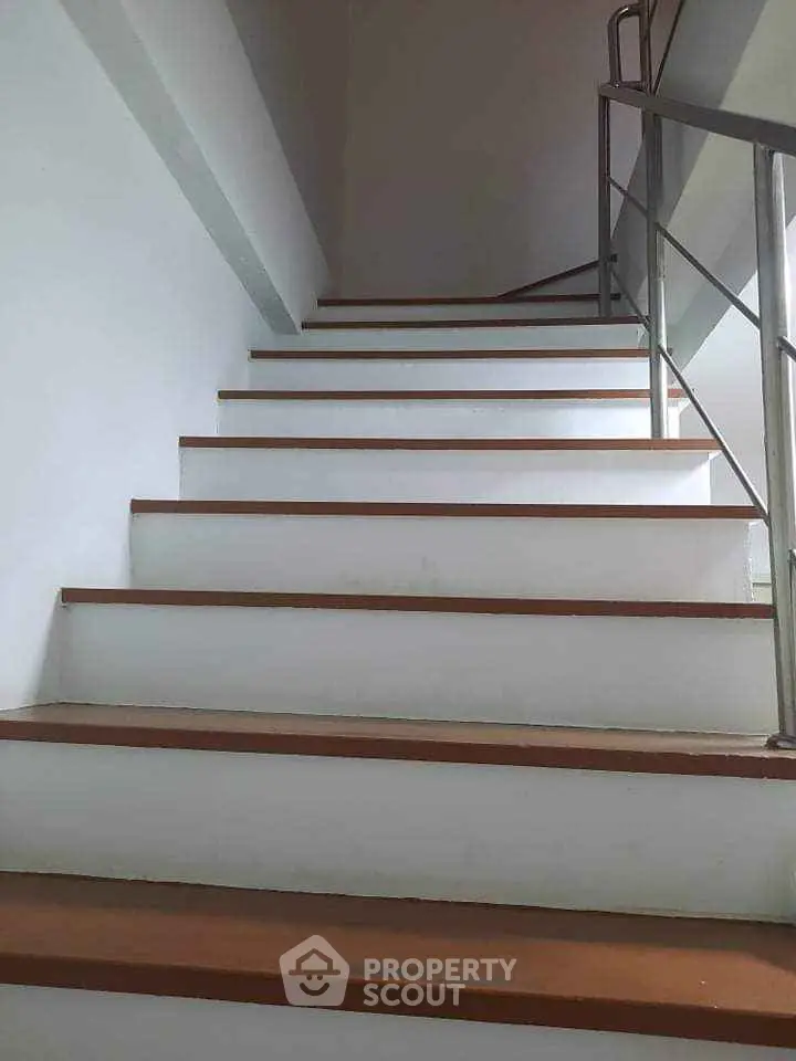 Modern staircase with sleek metal railing in a contemporary building