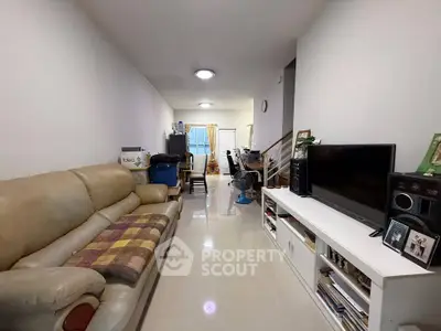 Spacious living room with modern furniture and entertainment setup, perfect for family gatherings.
