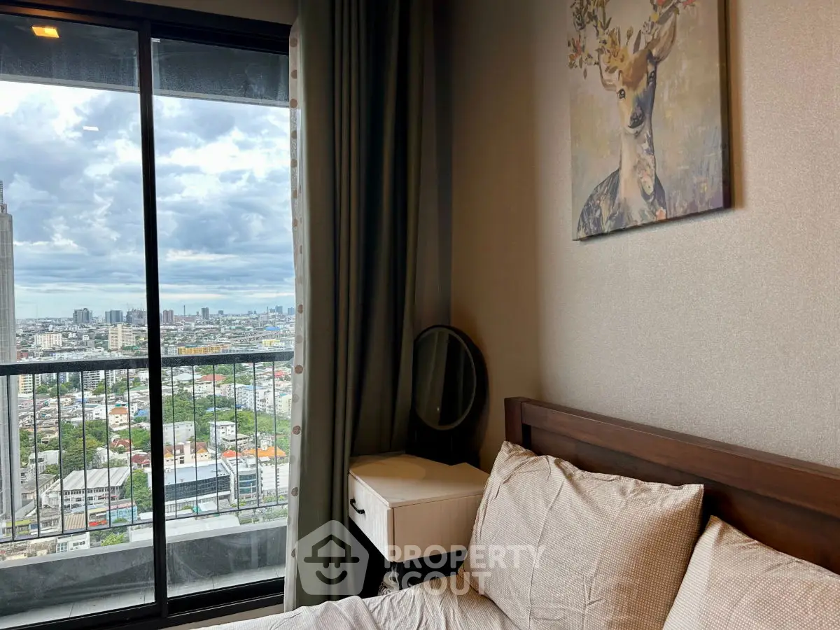 Cozy bedroom with stunning city view from balcony, featuring elegant decor and natural light.