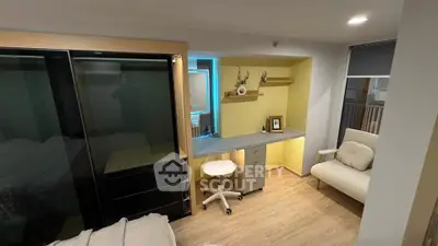 Modern study room with sleek desk, comfortable chair, and stylish decor in a cozy apartment.