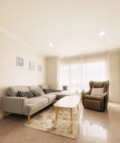 Bright and cozy living room with modern furniture and large windows