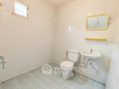 Spacious bathroom with minimalist design and tiled flooring